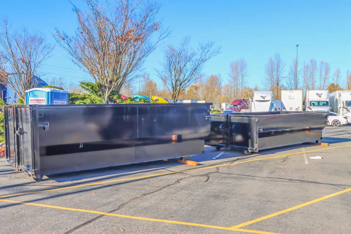 Professional dumpster rental service with roll-off container on residential driveway in Marion